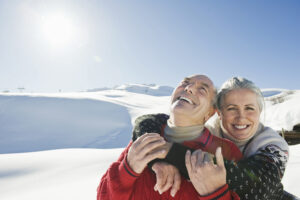 Italy, South Tyrol, Seiseralm, Senior couple embracing in winter scenery, portrait, close-up